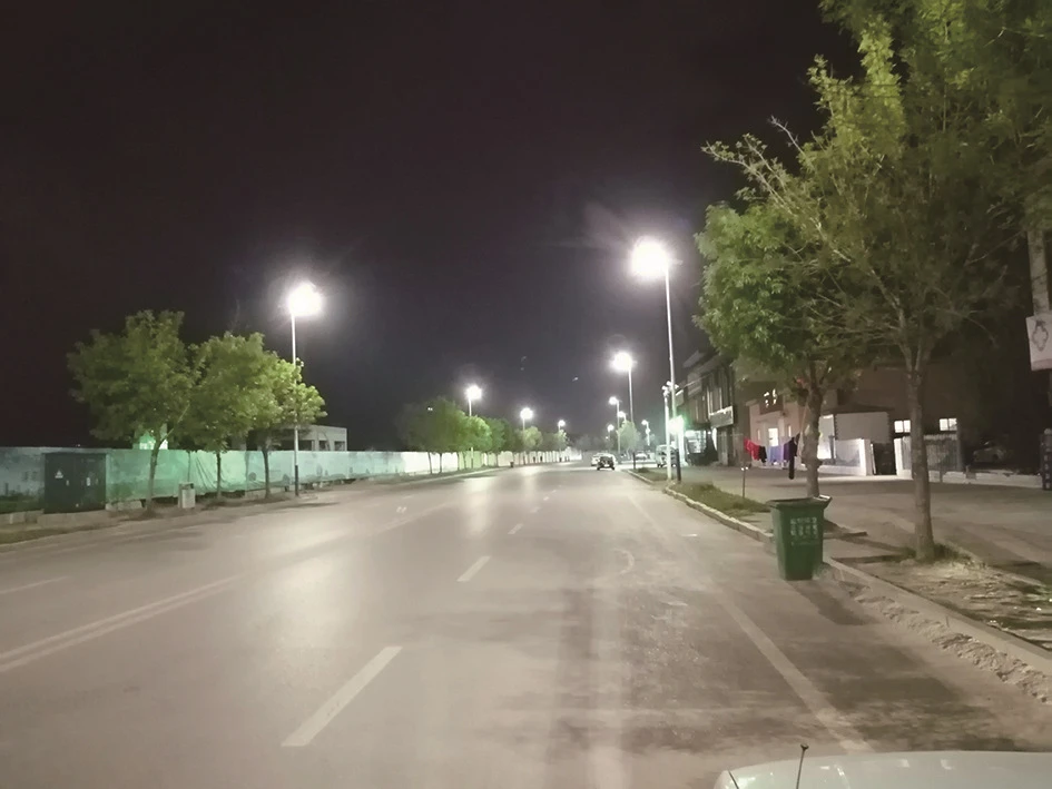 LED solar street lights illuminating an urban road at night LED solar street lights illuminating an urban road at night